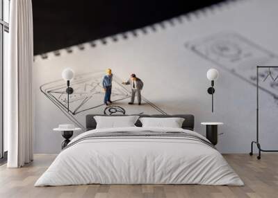 User Experience Concept. present by two Miniature Figure of Businessman standing on Paper of Interface Design Sketch at Night. Overtime Work Wall mural