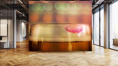 Woman Drinking Beer Concept. Closeup of Glass of Beer with Red Lipstick Mark in Bar or Restaurant. Feminine Mood Wall mural