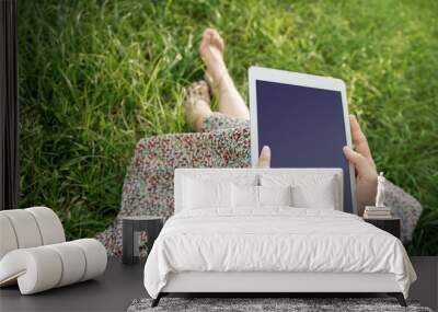 Woman relaxing and using tablet in Summer, Top view Wall mural