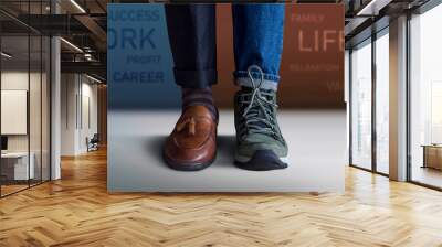 Work Life Balance Concept. Low Section of a Man Standing with Half of Working Shoes and Casual Traveling Shoes, Blurred Text on the Wall as background Wall mural