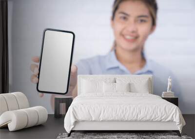 women holding phone showing white screen Wall mural