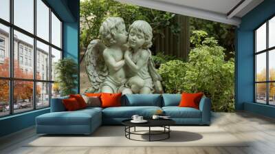 Cute kissed couple cupid in garden Wall mural