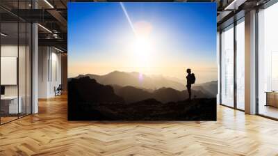 Woman hiking success silhouette in mountains sunset Wall mural