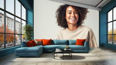 Beautiful african american girl with an afro hairstyle smiling. Smiling beautiful afro girl. Curly black hair. Emotion concept. Wall mural