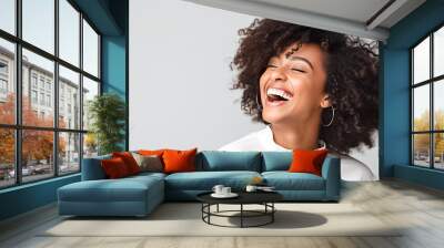 Beautiful african american girl with an afro hairstyle smiling. Smiling beautiful afro girl. Curly black hair. Emotion concept.
 Wall mural