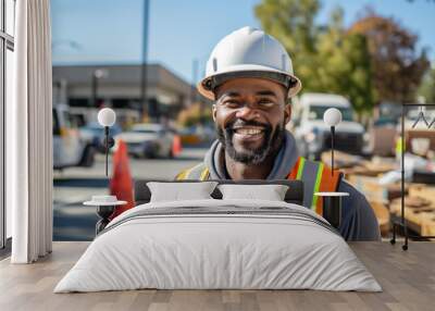 Portrait of an African American construction worker. He is wearing a orange construction helmet and vest.

 Wall mural