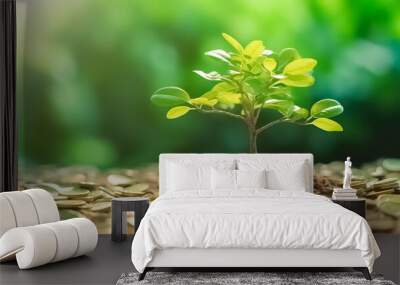 Small trees on a pile of gold coins and a natural green background. Financial or money growing concept.
 Wall mural