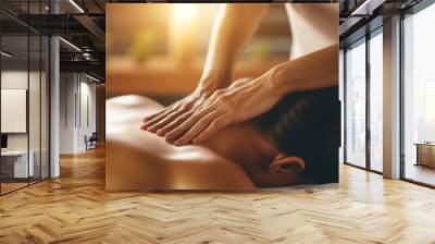 Women's hands make a therapeutic neck massage for a girl lying on a massage couch in a massage spa salon.  Wall mural