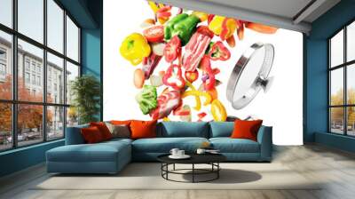 Cooking concept. Vegetables and meat are flying out of the pan isolated on white background. Healthy food. Wall mural