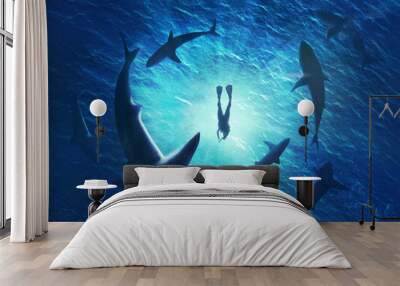 Illustration of sharks forming a circle under a man in water Wall mural