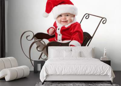 Smiling santa baby sitting in a sleigh Wall mural