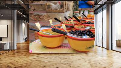 Fresh olives beautifully presented in ceramic bowls at the market in Saint-Tropez, Provence, France, blurred background Wall mural