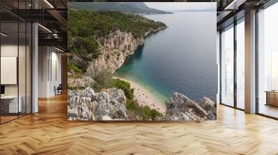 Scenic Nugal Beach-pebbly beach preferred by nudists-below a huge vertical rock wall towering above turquoise water at Gradac viewpoint with a stunning view to the coastline and Mount Biokovo, Croatia Wall mural