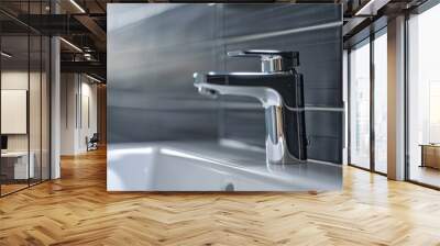 A closeup of a sleek chrome faucet against a dark tiled wall Wall mural