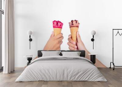 Two boy hand holding Strawberry and Chocolate Ice Cream Cone isolated on white background. Wall mural