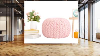 A cozy interior scene featuring a pink knitted pouf, flowers, books, and decorative items on a light background. Wall mural