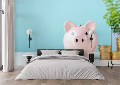 A cute pink piggy bank surrounded by coins, symbolizing savings and financial security in a bright, modern setting. Wall mural