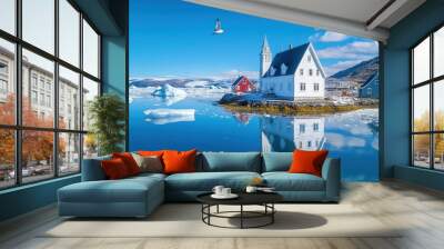 A stunning reflection of a white house near icy waters, surrounded by scenic mountains and clear blue skies. Wall mural