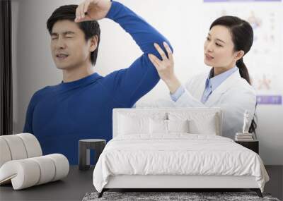 Female doctor examining patient Wall mural