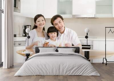 Portrait of a family eating breakfast Wall mural