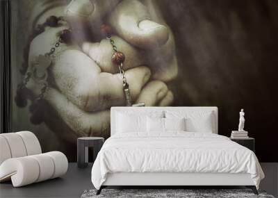 Old wrinkled woman hands holding a rosary. Closeup of christian  woman hands holding rosary while praying God. Wall mural