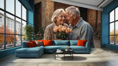 Senior couple holding roses smiling at each other Wall mural