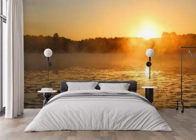 The sunrise over the lake is reflected on the surface of the water. Wall mural