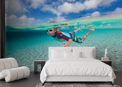 Boy swimming underwater Wall mural