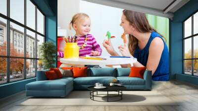 mother and daughter playing with finger toys Wall mural