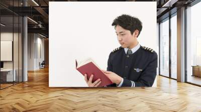 Airline pilot reading a book Wall mural