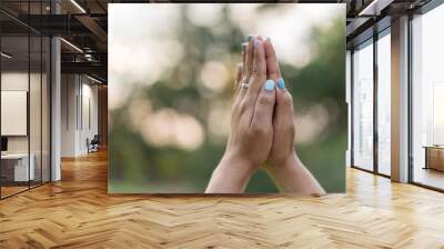 Asia woman Praying hands with faith in religion. Wall mural