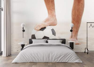 Close-up of male foot playing football on sand. Wall mural