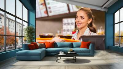 restaurant worker serving two fast food meals with smile. Wall mural