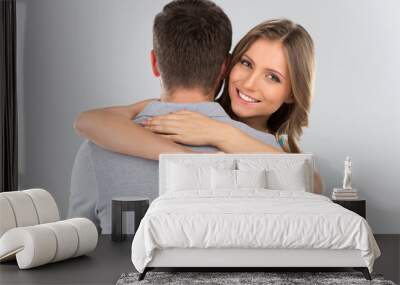 Young couple hugging with wrapped present. Wall mural