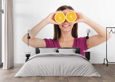 young girl holding two oranges. Wall mural