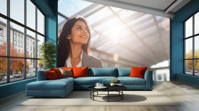 Business woman businesswoman walking smiling in office building Wall mural