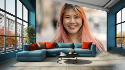 Young Asian woman with pink hair smile happy face portrait Wall mural