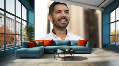 Young Latino Hispanic man in city smile happy face  Wall mural