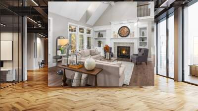 Beautiful living room in new traditional style luxury home. Features vaulted ceilings, fireplace with roaring fire, and elegant furnishings. Wall mural