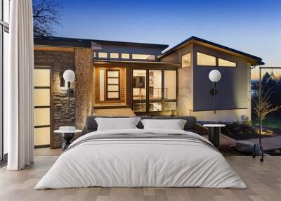 Beautiful modern style luxury home exterior at sunset with glowing interior lights. Wall mural