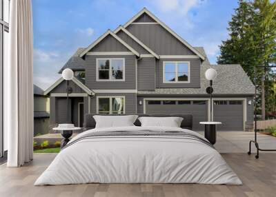 Front exterior of new home on sunny day. Features covered porch, three car garage, and gables Wall mural