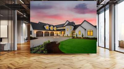 Stunning Luxury Home Exterior at Sunset with Colorful Sky. This Mansion has Three Garages, Turret Style Tower, and Two Floors Wall mural