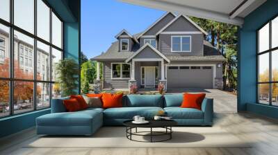 Suburban home exterior on bright sunny day, with large yard and covered porch Wall mural