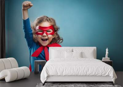 little superhero girl throws up his fists and rejoices in his success Wall mural