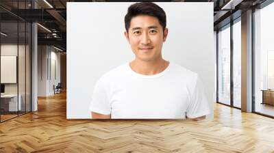 Portrait of an smiling attractive asian man in his 30s isolated against a white background Wall mural