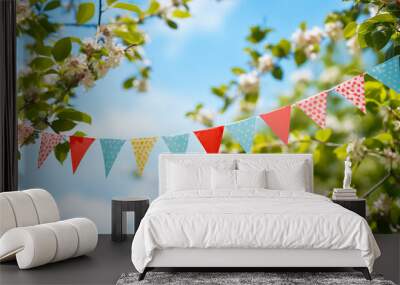 string of colorful pennant against blue sky in the garden as a summer party decoration Wall mural