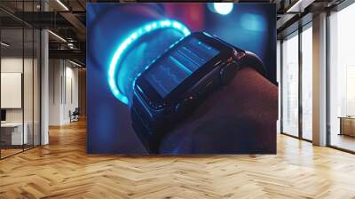 Close-up of a wearable fitness tracker on a wrist, display lit up. Wall mural