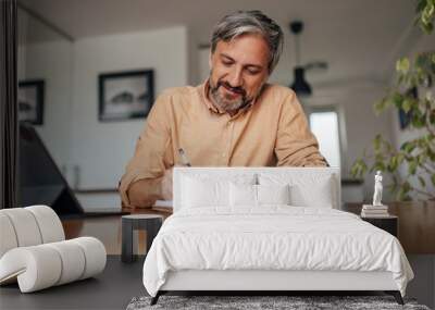 Adult man, doing his taxes on regular basis. Wall mural