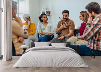 An upset man told his problems, looking emotional during the group therapy. Wall mural