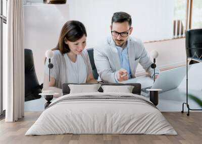 Business people working together on laptop in office at desk Wall mural